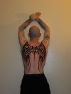 tribal angel wing tattoo on back